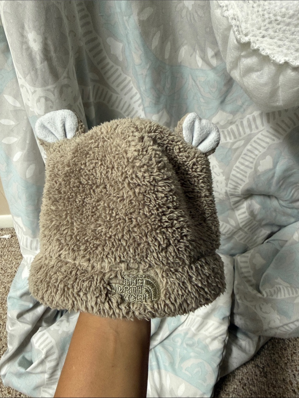 The North Face Kids Teddy Fleece Beanie Hat in Taupe with White Ear Accents. 3-6